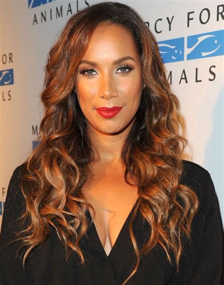 Leona Lewis' husband, Dennis Jaunch, kisses her hand on a red carpet