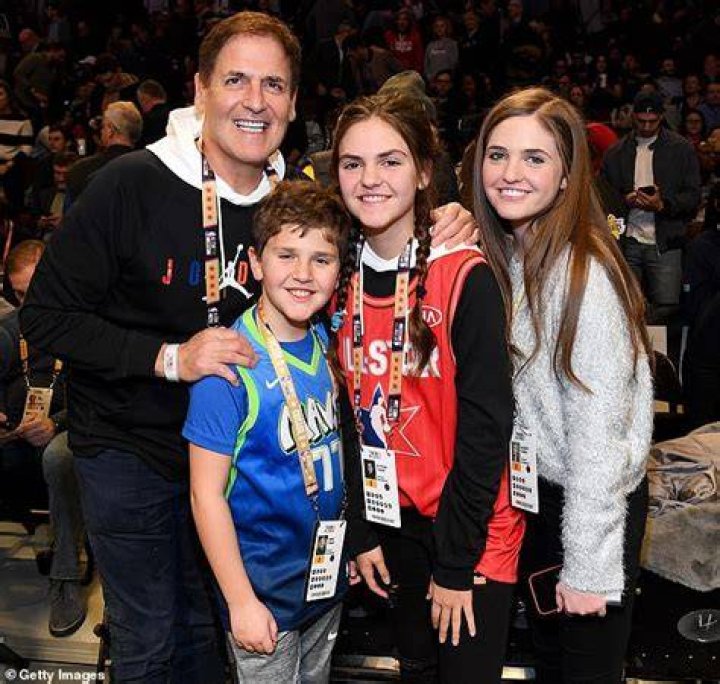 Mark Cuban with his three kids at the match of Dallas Mavericks. 